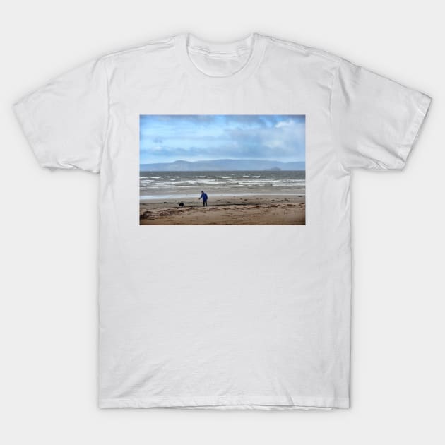 Walking the dog in blustery weather at Ardrossan, North Ayrshire, Scotland T-Shirt by richflintphoto